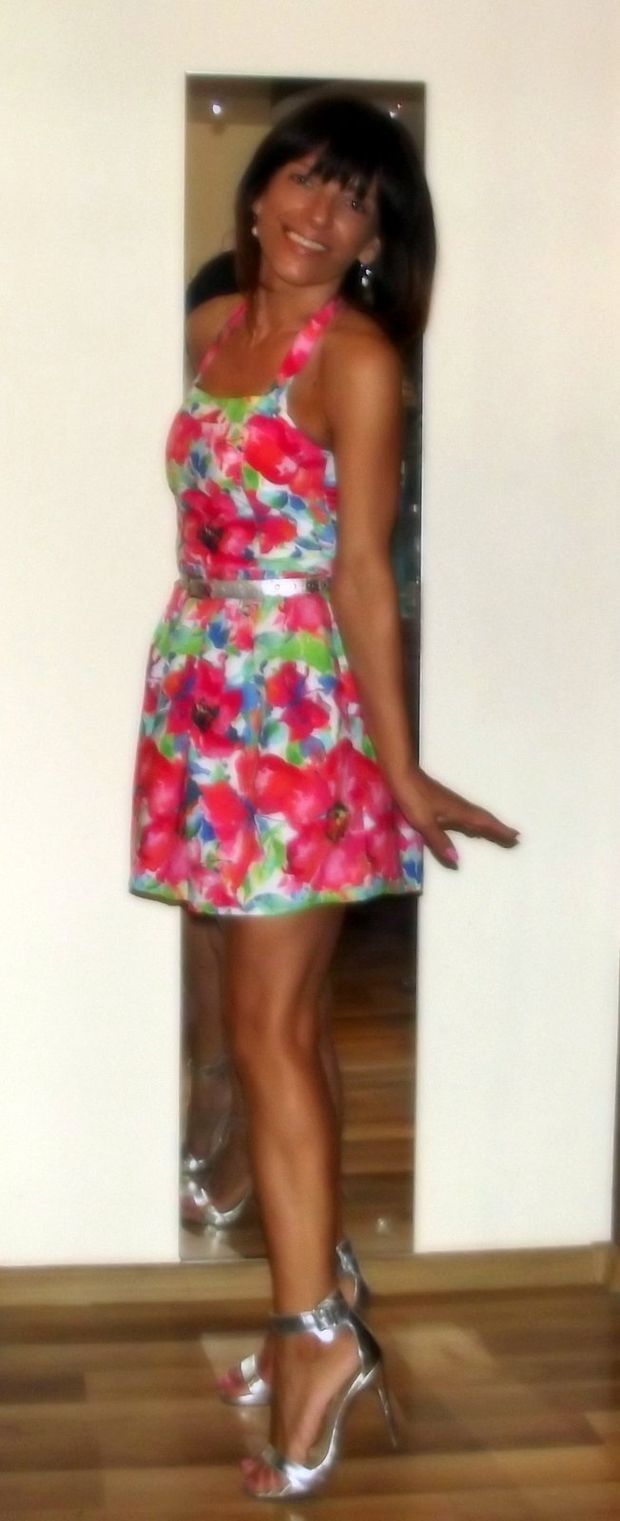 Tanned brunette mature in mini dress and sliver heeled sandals