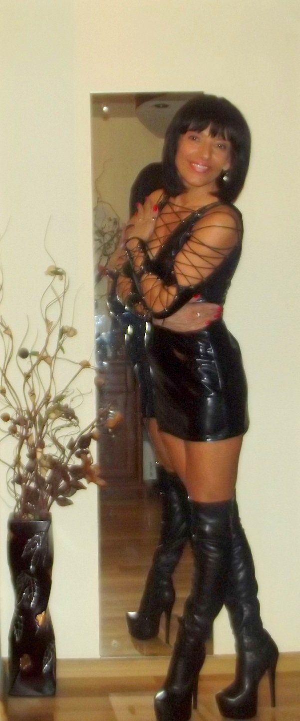 Nice mature mistress in really tight black latex dress and heeled boots
