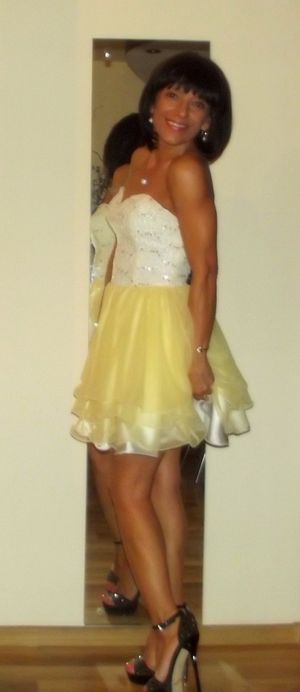 Tanned mature in cute mini dress