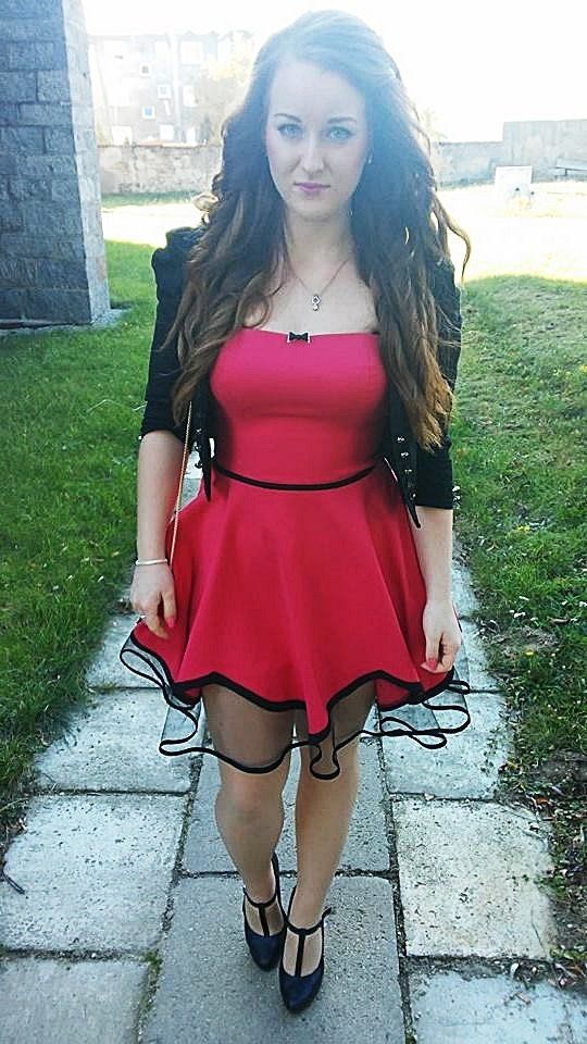 Seductive brunette in really sexy red dress, outdoors