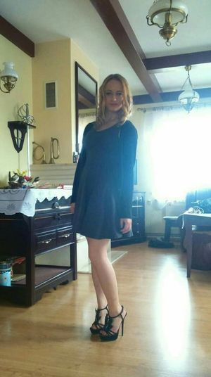 Blonde amateur posing in black heeled sandals at home