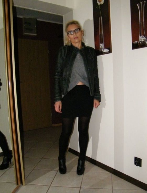 Blonde mature in black mini skirt and leather ankle boots