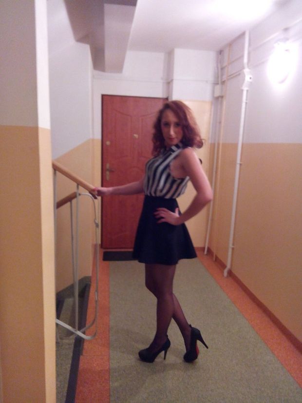 Redhead in mini skirt at the staircase