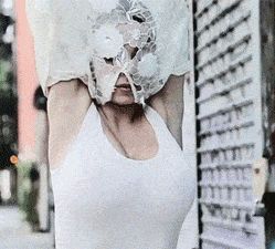 Blonde in see through top walking down the street