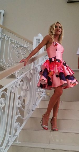 Tanned blonde bimbo in her princess pink dress