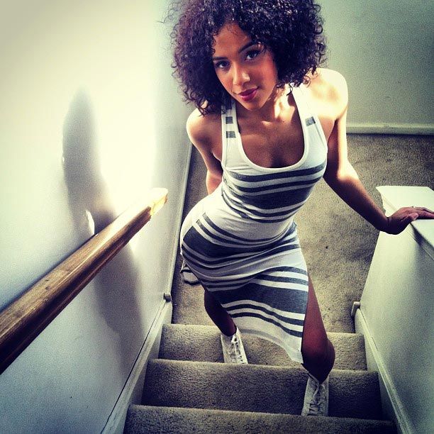 curly hair striped dress sneakers stairs