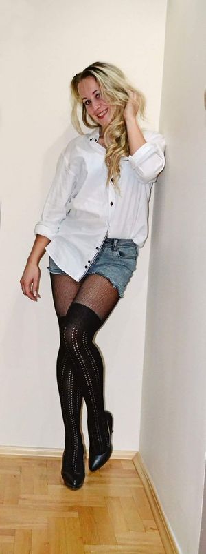 Blonde in white shirt and jeans mini skirt