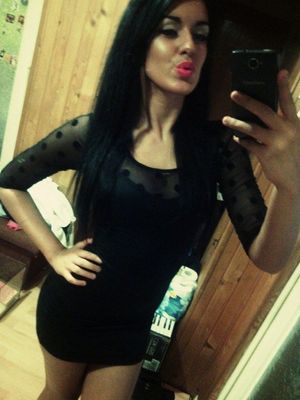 Dark hair bimbo in thight mini dress taking duckface selfie