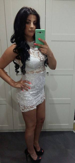 Dark hair bimbo taking a selfie of her in slutty lace dress, before going out
