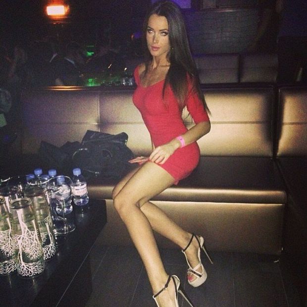 Sexy leggy chick in really tight and short red dress and high heeled sandals in da club