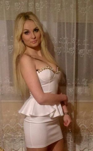 Curvy and sexy blonde in really nice tight white mini dress