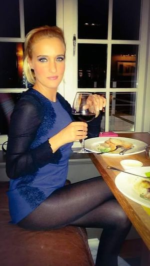 Leggy blonde in really short dress at the during the dinner