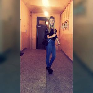 Sexy blonde amateur in tight jeans and black heeled ankle-boots