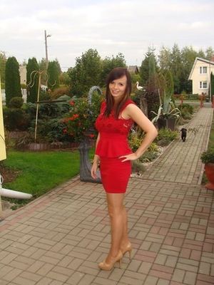 Sexy brunette in nice tight red dress outdoors