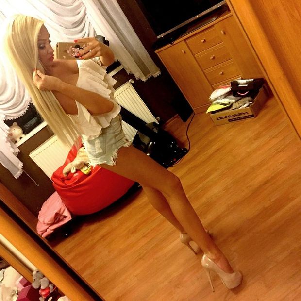Busty leggy blonde bimbo posing before going out for a wild party