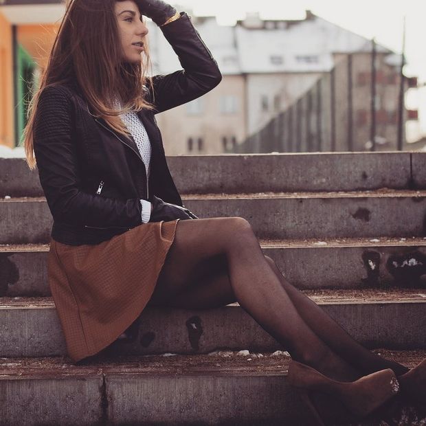 Nice leggy brunette posing outdoors in brown leather skirt and nice high heeled platforms