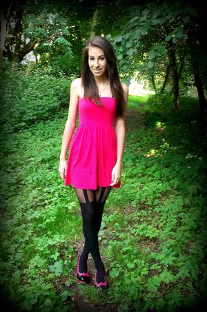 Nice cute chick posing outdoors in mini pink dress