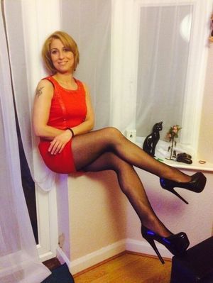Smoking hot blonde mummy in really sexy red mini dres, black fishnet stockings and shiny high heeled platforms