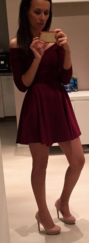 Leggy brunette in red loose mini dress