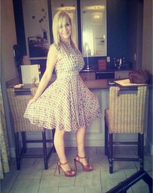 Sexy mature blonde posing in nice dress and brown high heeled sandals