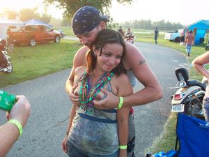 Groping her boobs outdoors.