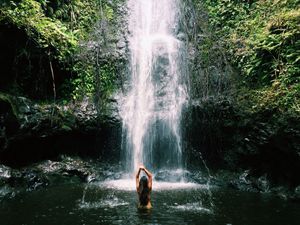 Brunette in the waterfall