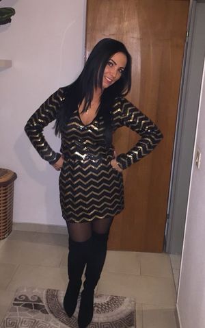 Sexy brunette in black boots and nice clevy dress