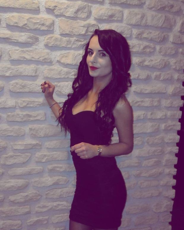Cute brunette in blak, braless party dress