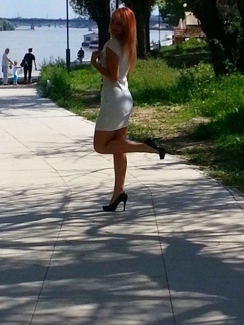 Redhead chick outdoors in tight white dress