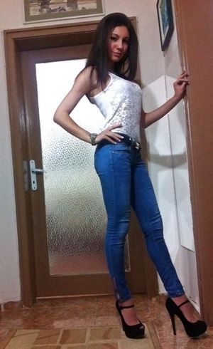 Sexy brunette in high heeled platforms and tight jeans