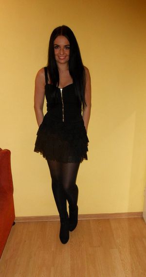 Nice brunette in black mini dress with sexy golden zipper