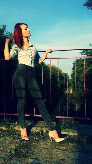 Redhead chick posing outdoors in nude stilettos and tight leggings