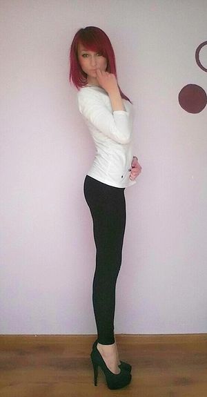 Sexy redhead sweetie in tight black leggins and high heeled platforms