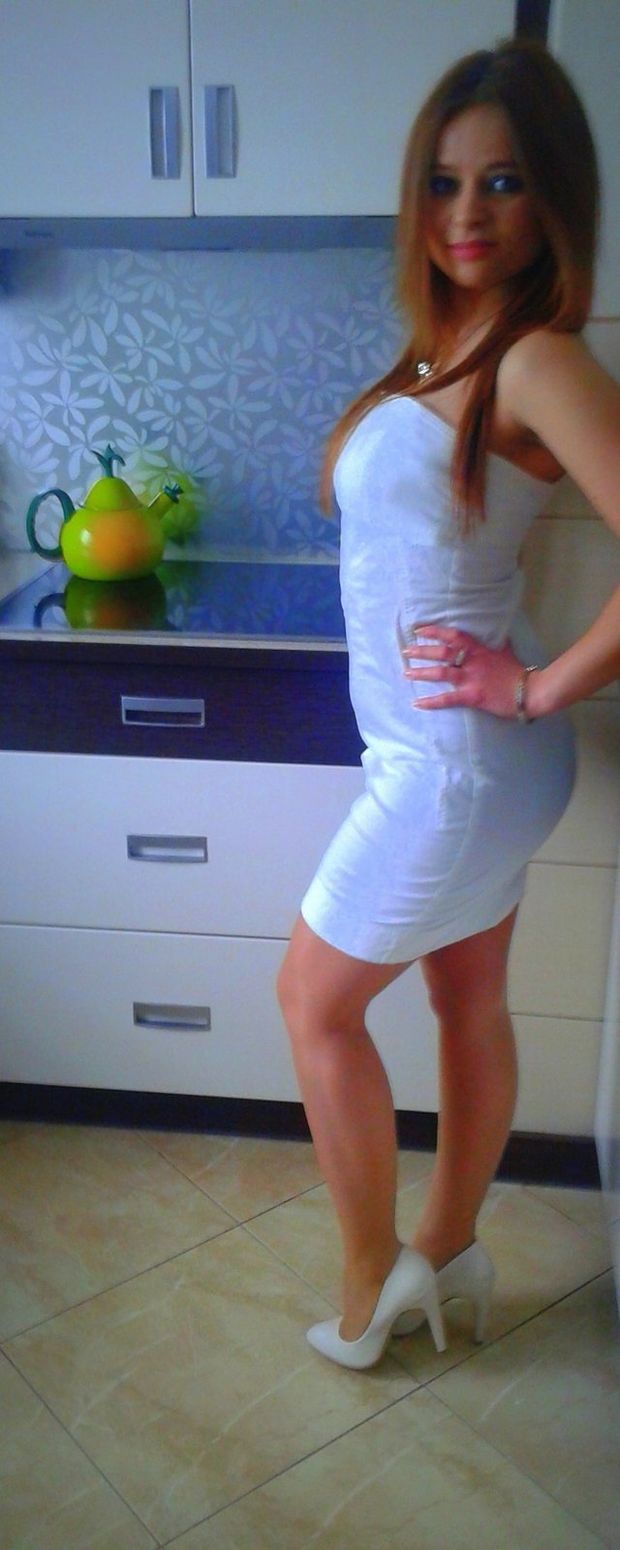 Redhead chick in shiny white mini dress
