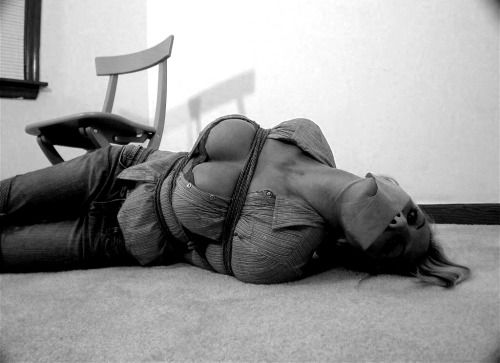 Courtney rope-tied with her breasts exposed. Download her full...
