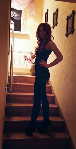 Leggy redhead in high heels