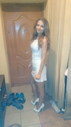 Blone babe in white mini dress and heels is going out