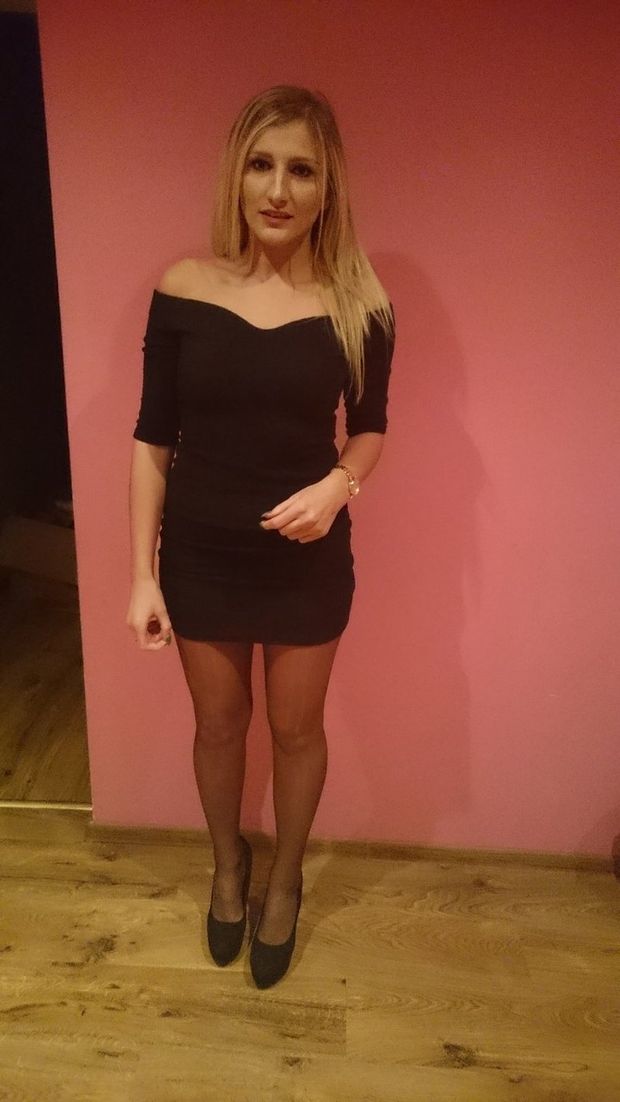 Blonde babe in tight black dress with bare shoulders