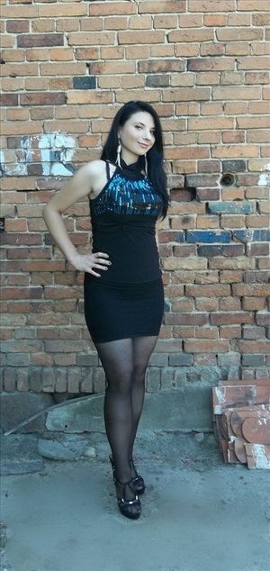 Curvy brunette in really tight mini dress, posing during pickup