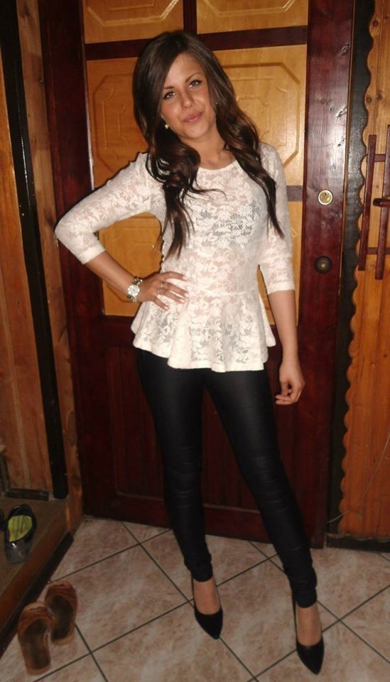 Brunette chick in black leggings and sheer blouse