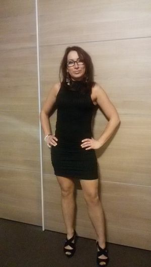 Nice mature brunette in black tight mini dress