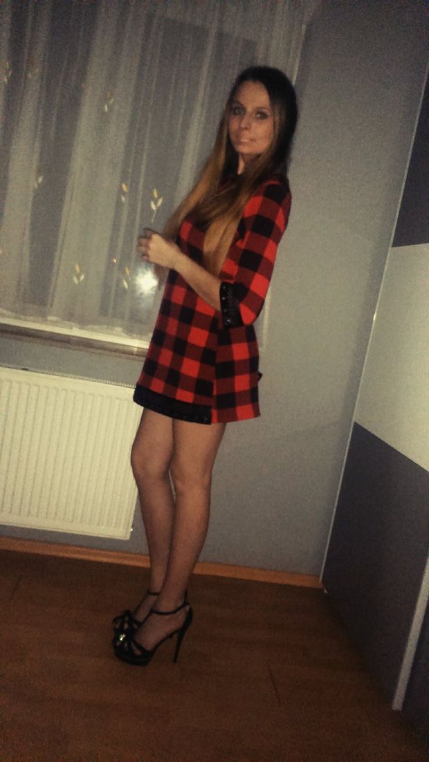 Blonde chick in checked mini dress and black high heeled sandals