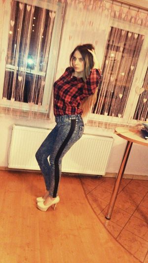 Dark blonde posing in tight jeans-like leggings and heels