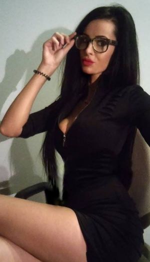 Dark hair busty bimbo in geek glasses