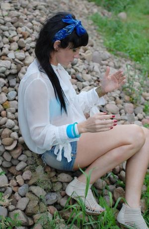 Brunette babe posing outdoors in see thru shirt