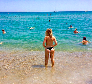 Hot blonde tanning topless in a thong on European beach