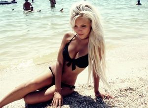 blonde on beach in black bikini looking fuckable