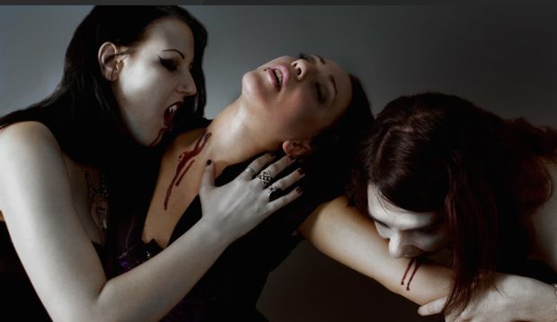 Two vampires enjoying their willing victims blood