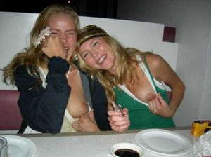 Friends flashing tit at table