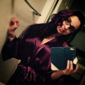 Super sexy beautiful woman in tight robe taking selfie